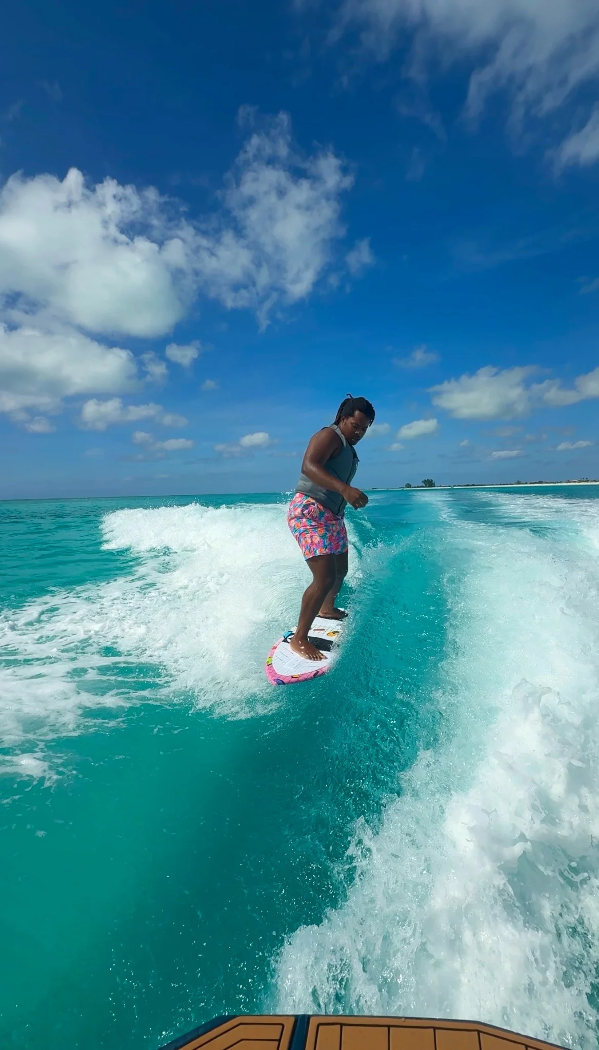 Beginner wakesurfer riding without the rope and practicing control on the wave
