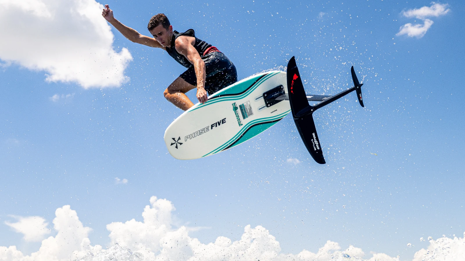 Parker Payne wakefoiling above the wave on a Phase Five foil board.